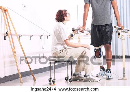 Picture - Physical therapist with patient . Fotosearch