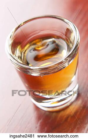 Stock Image - Shot glass of liquor an 3. Fotosearch