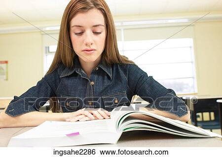 Student sitting at desk a84 View Large Photo Image Stock Photograph - Student sitting at desk a84. Fotosearch