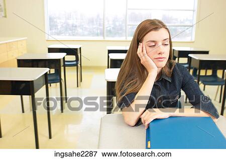 Student sitting at desk a85 View Large Photo Image Stock Photo - Student sitting at desk a85. Fotosearch