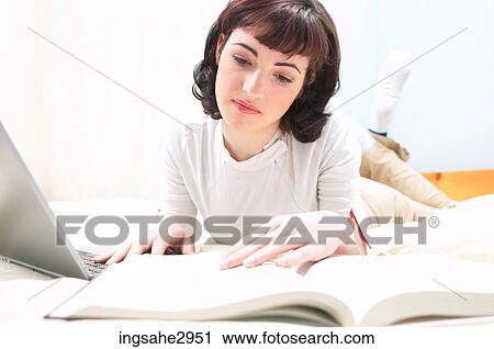 Stock Image - Student studying with laptop . Fotosearch