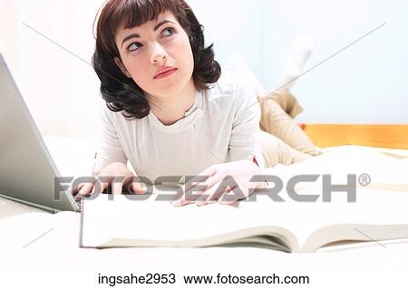 Stock Image - Student studying with laptop . Fotosearch