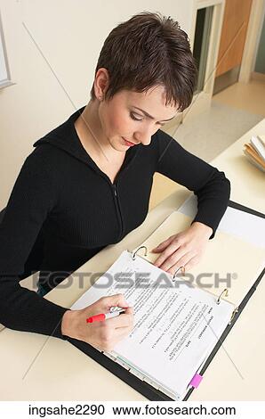 Teacher sitting at desk a81 View Large Photo Image Stock Image - Teacher sitting at desk a81. Fotosearch
