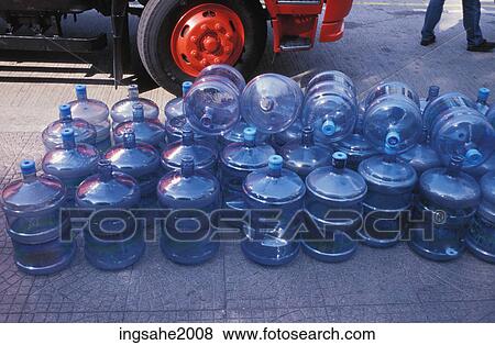 Water bottles on sidewalk View Large Photo Image Stock Photo - Water bottles on sidewalk. Fotosearch
