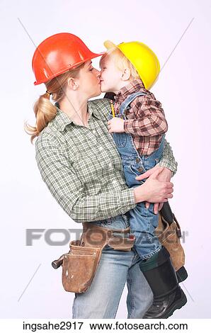 Woman holding little boy View Large Photo Image Stock Photo - Woman holding little boy . Fotosearch