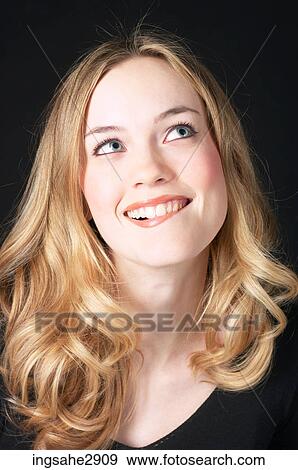 Stock Photo - Woman in front of black background . Fotosearch
