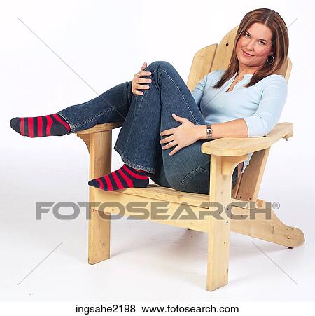 Woman relaxing in wooden lounge chair View Large Photo Image Stock Photo - Woman relaxing in wooden lounge chair . Fotosearch