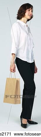 Stock Image - Woman shopping for fruit . Fotosearch
