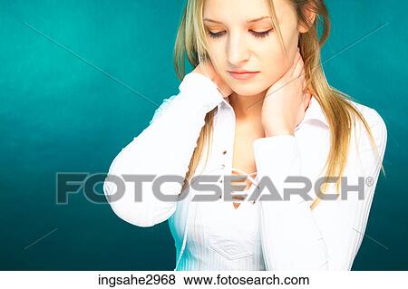 Young girl rubbing her neck View Large Photo Image Stock Photo - Young girl rubbing her neck . Fotosearch