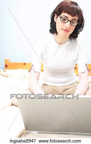 Stock Photo - Young woman using laptop . Fotosearch