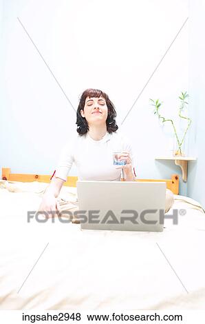 Stock Photo - Young woman using laptop . Fotosearch
