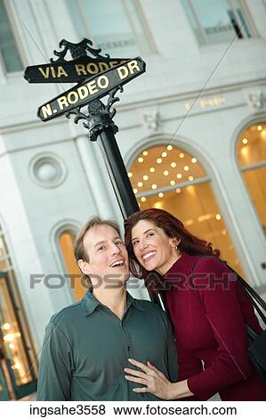 Stock Photo - Adult couple at Rodeo Drive shopping center . Fotosearch