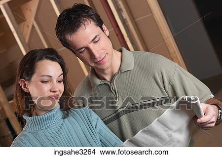 Picture - Adult couple looking at blue prints . Fotosearch