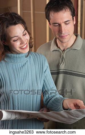Adult couple looking at blue prints View Large Photo Image Stock Image - Adult couple looking at blue prints . Fotosearch