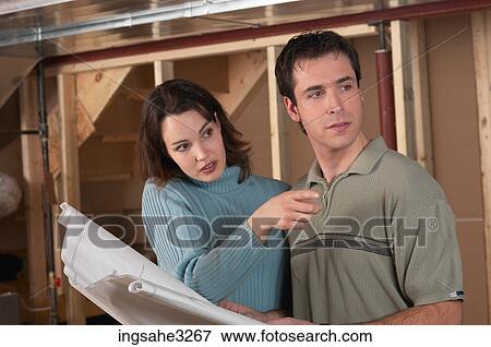 Adult couple looking at blue prints View Large Photo Image Stock Photo - Adult couple looking at blue prints . Fotosearch