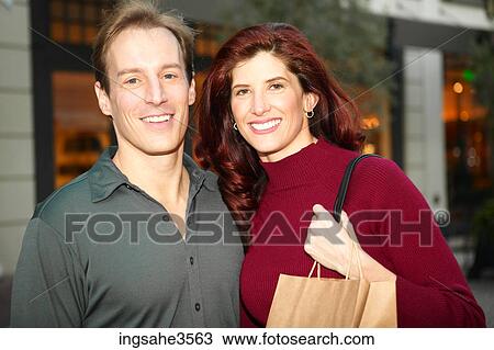 Adult couple with shopping bags View Large Photo Image Stock Image - Adult couple with shopping bags . Fotosearch