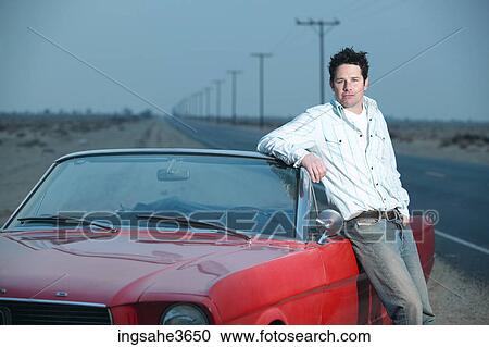 Adult standing next to car View Large Photo Image Stock Image - Adult standing next to car . Fotosearch