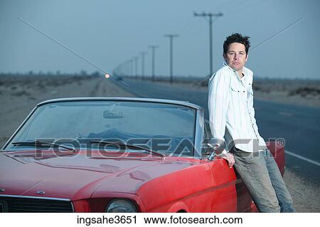 Adult standing next to car View Large Photo Image Stock Image - Adult standing next to car . Fotosearch