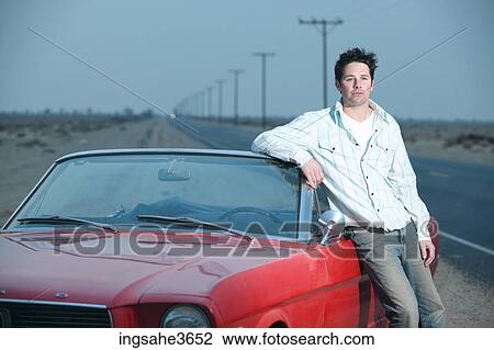 Adult standing next to car View Large Photo Image Stock Image - Adult standing next to car . Fotosearch