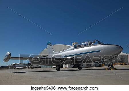 Stock Photograph - Airplane in front of hanger . Fotosearch