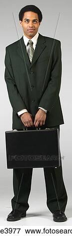 Bored businessman in black suit with briefcase View Large Photo Image Stock Photo - Bored businessman in black suit with briefcase. Fotosearch
