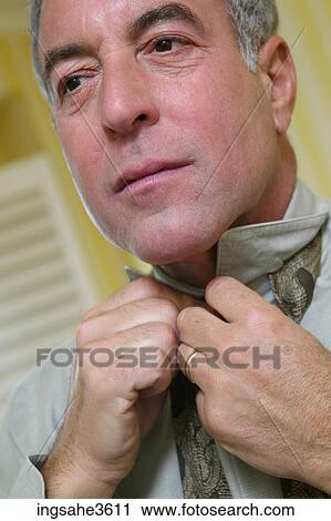 Stock Image - Business man getting dressed . Fotosearch