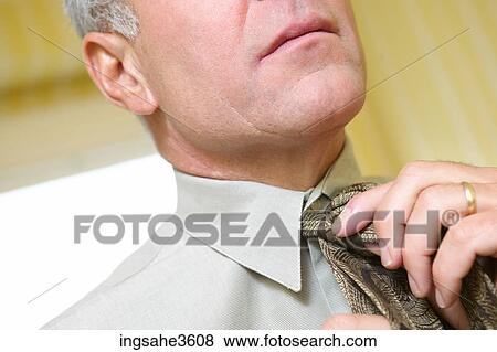Stock Photo - Business man getting dressed . Fotosearch