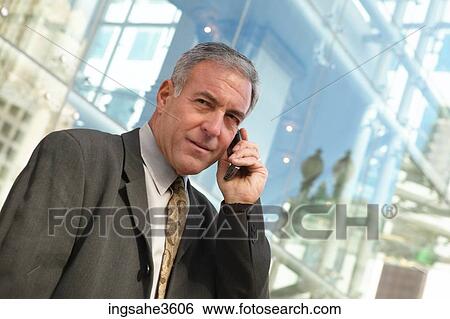 Business man on cellphone View Large Photo Image Stock Photograph - Business man on cellphone . Fotosearch