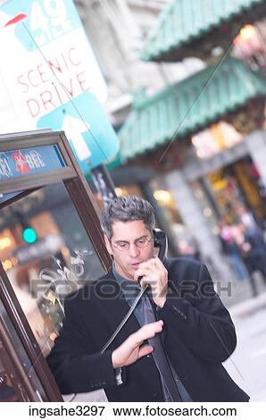 Business man on pay phone View Large Photo Image Stock Photo - Business man on pay phone . Fotosearch