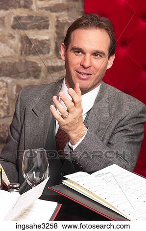 Businessman at meeting with date books View Large Photo Image Stock Photo - Businessman at meeting with date books . Fotosearch