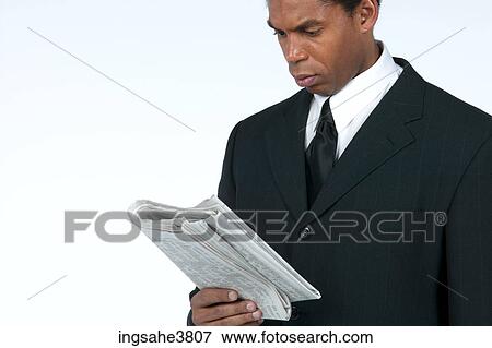 Businessman reading newspaper View Large Photo Image Stock Photo - Businessman reading newspaper . Fotosearch