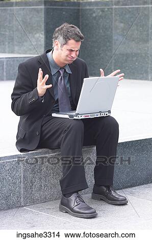 Businessman sitting with laptop View Large Photo Image Picture - Businessman sitting with laptop . Fotosearch