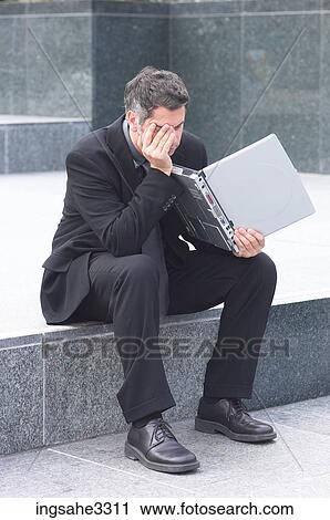 Businessman sitting with laptop View Large Photo Image Stock Image - Businessman sitting with laptop . Fotosearch