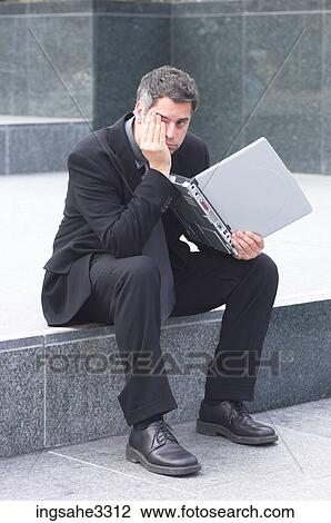 Businessman sitting with laptop View Large Photo Image Stock Image - Businessman sitting with laptop . Fotosearch