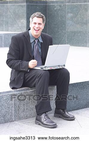 Businessman sitting with laptop View Large Photo Image Stock Image - Businessman sitting with laptop . Fotosearch