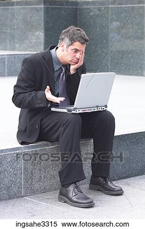 Businessman sitting with laptop View Large Photo Image Stock Photography - Businessman sitting with laptop . Fotosearch