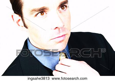 Businessman straightening tie View Large Photo Image Stock Image - Businessman straightening tie . Fotosearch