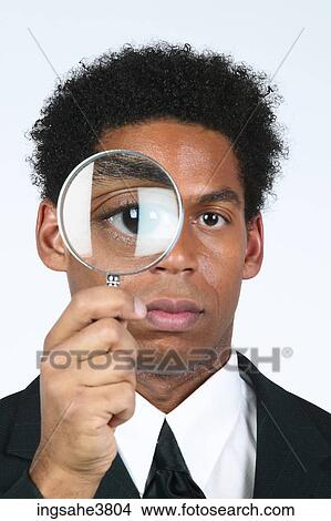 Businessman with magnifying glass View Large Photo Image Picture - Businessman with magnifying glass . Fotosearch