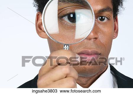 Businessman with magnifying glass View Large Photo Image Stock Image - Businessman with magnifying glass . Fotosearch