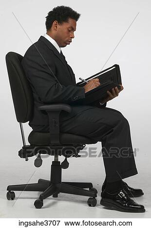 Businessman writing in folder View Large Photo Image Stock Photo - Businessman writing in folder . Fotosearch