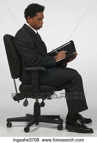 Businessman writing in folder View Large Photo Image Stock Photo - Businessman writing in folder . Fotosearch