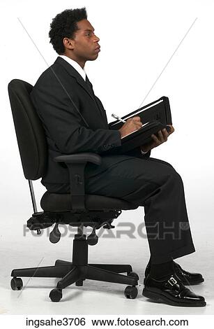 Businessman writing in folder View Large Photo Image Stock Photograph - Businessman writing in folder . Fotosearch