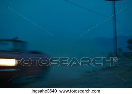 Car driving on dirt road at night View Large Photo Image Stock Image - Car driving on dirt road at night . Fotosearch