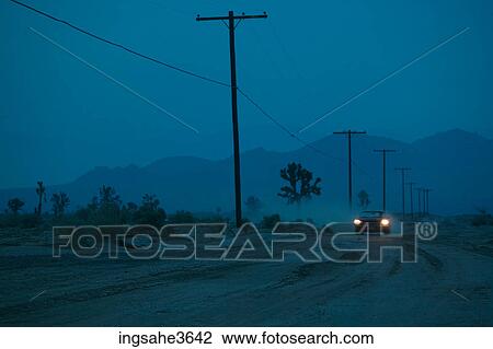 Car driving on dirt road at night View Large Photo Image Stock Image - Car driving on dirt road at night . Fotosearch