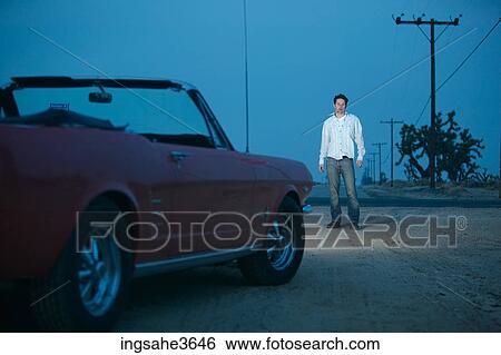 Stock Photograph - Car driving on dirt road at night . Fotosearch