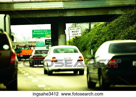 Stock Image - Cars on highway with overpass . Fotosearch