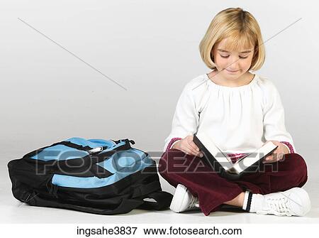 Caucasian blonde girl sitting cross legged with a backpack and reading View Large Photo Image Stock Photo - Caucasian blonde girl sitting cross legged with a backpack and reading. Fotosearch