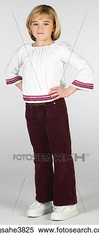 Stock Photography - Caucasian blonde girl standing and frowning. Fotosearch