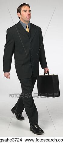 Executive smiling and walking View Large Photo Image Picture - Executive smiling and walking . Fotosearch