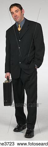 Executive standing with a smile View Large Photo Image Stock Image - Executive standing with a smile . Fotosearch